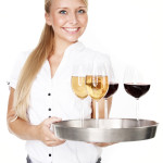 Pretty lady waitress with four glasses of wine