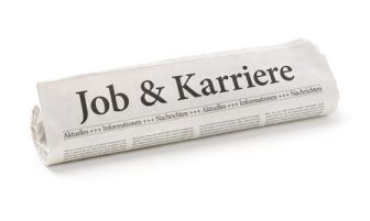 Zeitungsrolle mit der Überschrift Job und Karriere